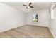 Bedroom with neutral carpet, ceiling fan, and a window overlooking the neighborhood at 9532 Water Fern Cir, Clermont, FL 34711