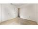 Neutral carpeted bedroom with two white doors and an open doorway at 9532 Water Fern Cir, Clermont, FL 34711