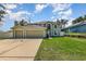 Inviting two story home featuring an attached three car garage and a well manicured lawn at 9532 Water Fern Cir, Clermont, FL 34711