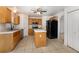 Open kitchen with a center island, tile floors, stainless appliances and ample cabinets at 9532 Water Fern Cir, Clermont, FL 34711