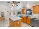 Bright eat-in kitchen with light wood cabinets, stainless steel appliances, and a view of the pool at 9532 Water Fern Cir, Clermont, FL 34711