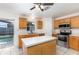 Open kitchen with a center island, stainless appliances, and access to a covered patio at 9532 Water Fern Cir, Clermont, FL 34711