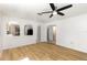 Open living room featuring arched doorways and attractive wood flooring at 9532 Water Fern Cir, Clermont, FL 34711