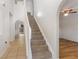 Bright entry staircase leading to upper level, featuring neutral carpet and white trim at 9532 Water Fern Cir, Clermont, FL 34711