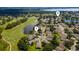 Wide aerial shot of the neighborhood featuring serene lakes and a well-maintained golf course at 9563 Myrtle Creek Ln, Orlando, FL 32832
