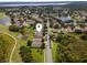 Aerial view of the home near a golf course and lake at 9563 Myrtle Creek Ln, Orlando, FL 32832