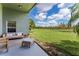 Inviting back patio with comfortable seating and scenic views of the backyard and pond at 9563 Myrtle Creek Ln, Orlando, FL 32832