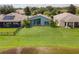 Well-maintained backyard featuring a lush lawn, a screened patio, and mature landscaping at 9563 Myrtle Creek Ln, Orlando, FL 32832