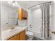 Bathroom with tub and shower combo, vanity with sink, and medicine cabinet at 9563 Myrtle Creek Ln, Orlando, FL 32832