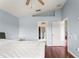 Bright bedroom featuring wood floors, en-suite bath, and a cozy ceiling fan at 9563 Myrtle Creek Ln, Orlando, FL 32832