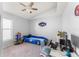 bedroom with blue racecar bed, ceiling fan, and themed decorations at 9563 Myrtle Creek Ln, Orlando, FL 32832