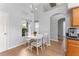 Cozy dining area with abundant natural light, complemented by modern fixtures and hardwood flooring at 9563 Myrtle Creek Ln, Orlando, FL 32832