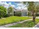 View of the manicured front lawn of the single story home with an attached two car garage at 9563 Myrtle Creek Ln, Orlando, FL 32832