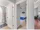 Hallway view into a bedroom and a bathroom, showcasing the home's layout at 9563 Myrtle Creek Ln, Orlando, FL 32832