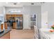 Well-lit kitchen featuring stainless appliances and a separate laundry area at 9563 Myrtle Creek Ln, Orlando, FL 32832