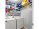 Laundry area featuring modern washer and dryer and ample shelving at 9563 Myrtle Creek Ln, Orlando, FL 32832