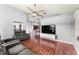 Open-concept living room with stylish furnishings, high ceilings, modern lighting, and hardwood floors at 9563 Myrtle Creek Ln, Orlando, FL 32832