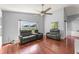 Spacious living room featuring modern ceiling fan, natural light, and cozy seating arrangements at 9563 Myrtle Creek Ln, Orlando, FL 32832