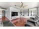 Bright living area with large television, recessed lighting, built-in shelving, and modern furniture at 9563 Myrtle Creek Ln, Orlando, FL 32832