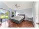 Bright main bedroom with sliding door access to the yard and hardwood flooring at 9563 Myrtle Creek Ln, Orlando, FL 32832