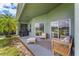 Comfortable covered patio area with outdoor furniture, ideal for relaxation and entertaining at 9563 Myrtle Creek Ln, Orlando, FL 32832