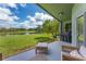 Beautiful view from the covered patio overlooking the green lawn and serene water feature at 9563 Myrtle Creek Ln, Orlando, FL 32832
