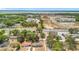Expansive aerial shot showcasing the neighborhood, nearby lake, and the property's proximity to local amenities at 1000 E Dixie Ave, Leesburg, FL 34748