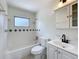 A cozy bathroom featuring a shower-tub, tiled backsplash, and vanity at 1000 E Dixie Ave, Leesburg, FL 34748
