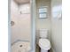 Bathroom featuring a walk-in shower, toilet and small window at 1000 E Dixie Ave, Leesburg, FL 34748