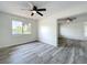 Bedroom featuring wood-look vinyl flooring, white walls, a window and ceiling fan at 1000 E Dixie Ave, Leesburg, FL 34748