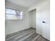 Cozy bedroom featuring gray wood-look flooring and a closet with views from a well-lit window at 1000 E Dixie Ave, Leesburg, FL 34748