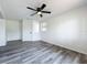 Bedroom featuring wood-look vinyl flooring, white walls and a ceiling fan at 1000 E Dixie Ave, Leesburg, FL 34748