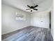 This bedroom is bright with hardwood floors and a window at 1000 E Dixie Ave, Leesburg, FL 34748