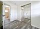 Bedroom features mirrored closet doors, gray wood-look floors, and easy access to the bath at 1000 E Dixie Ave, Leesburg, FL 34748