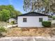 A side view of the home showing the carport and storage shed at 1000 E Dixie Ave, Leesburg, FL 34748