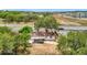 Charming single-story home with mature trees, covered carport, and a glimpse of the bustling street at 1000 E Dixie Ave, Leesburg, FL 34748