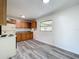 Functional kitchen with wood cabinets, laminate flooring, and a view to the outside at 1000 E Dixie Ave, Leesburg, FL 34748