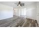 Newly renovated living room featuring fresh paint, new laminate flooring and a ceiling fan at 1000 E Dixie Ave, Leesburg, FL 34748