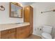 Bathroom with vanity, sink, medicine cabinet, and toilet at 10059 Sali Dr, Orlando, FL 32817
