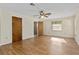 Bedroom with wood flooring, two closets, a ceiling fan with light, and a window at 10059 Sali Dr, Orlando, FL 32817