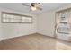 Neutral bedroom with carpet, two windows, and a ceiling fan with light at 10059 Sali Dr, Orlando, FL 32817