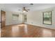 Spacious bedroom featuring wood floors, ceiling fan, and natural light at 10059 Sali Dr, Orlando, FL 32817