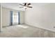 Spacious bedroom featuring neutral carpet, ceiling fan, and natural light from the window at 10059 Sali Dr, Orlando, FL 32817