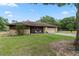 Charming home features stone accents, a cozy porch, and a well-manicured lawn at 10059 Sali Dr, Orlando, FL 32817