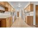 Spacious kitchen features light wood cabinets, white appliances, and tile flooring at 10059 Sali Dr, Orlando, FL 32817