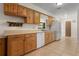 Functional kitchen with wood cabinets, neutral countertops, and tile flooring at 10059 Sali Dr, Orlando, FL 32817