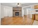 Cozy living room features a brick fireplace and hardwood flooring at 10059 Sali Dr, Orlando, FL 32817