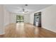 Open living area with light hardwood floors, ceiling fan, and access to the outdoors at 10059 Sali Dr, Orlando, FL 32817