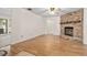 Inviting living room features a brick fireplace and hardwood flooring at 10059 Sali Dr, Orlando, FL 32817