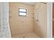 Tiled shower with window and shelving at 10059 Sali Dr, Orlando, FL 32817